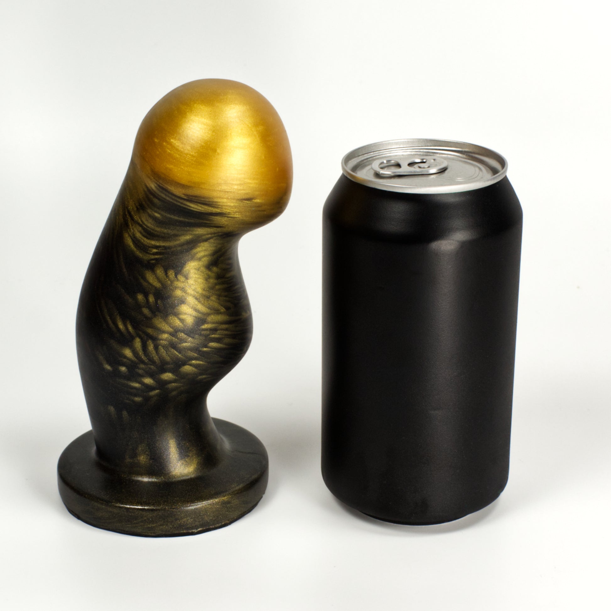 Side view of the Ally Large next to a standard soda can, showing that the toy is a little taller than the can and nearly as wide at the middle bump.