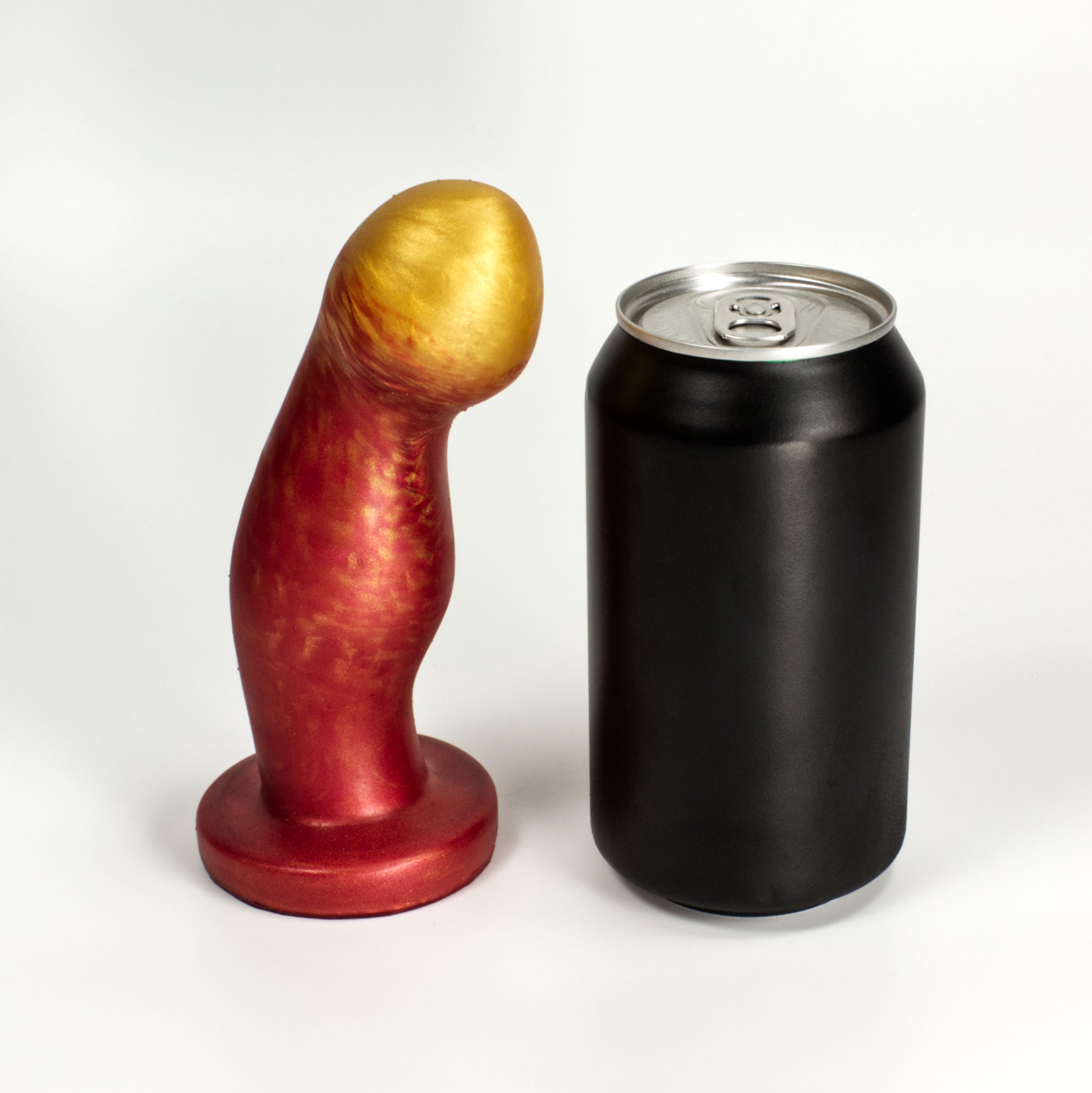 Side view of the Ally Small next to a standard soda can, showing that the toy is a little taller than the can and two thirds as wide at the middle bump.