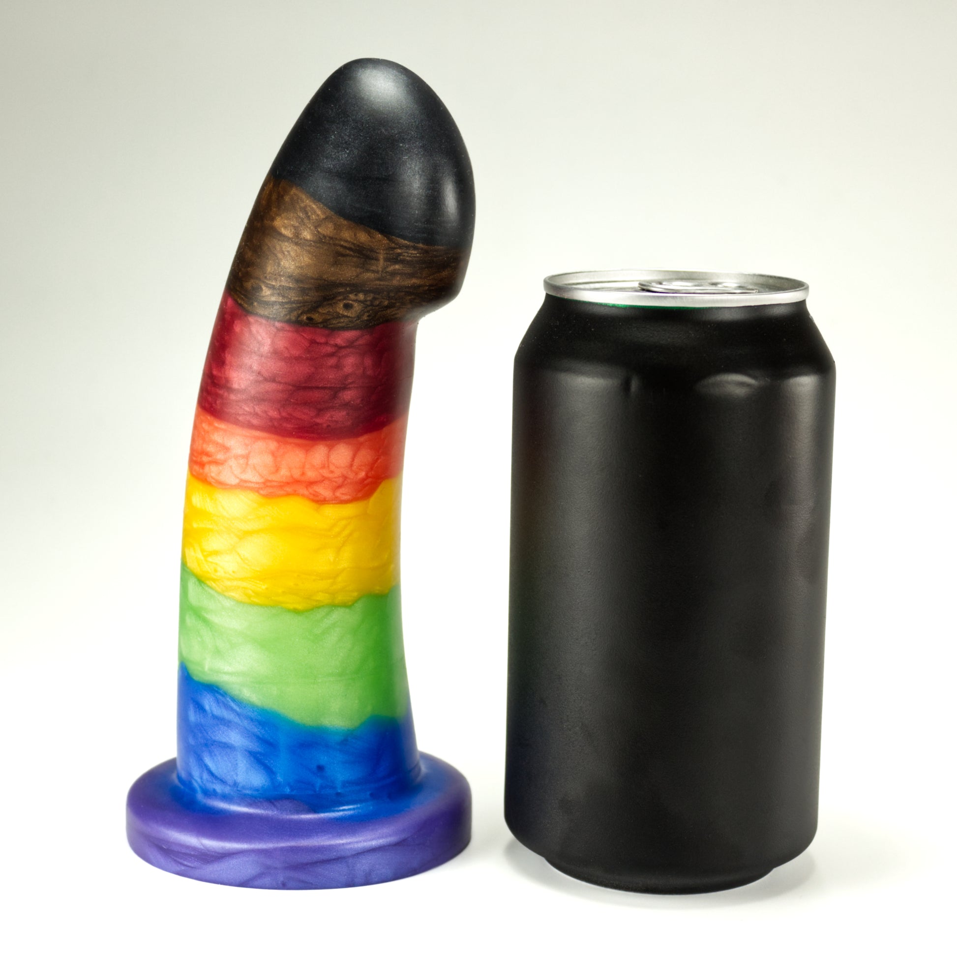 Side view of the Sidekick Large next to a standard soda can, showing that the dildo is a little taller and about three quarters of the width of the can.