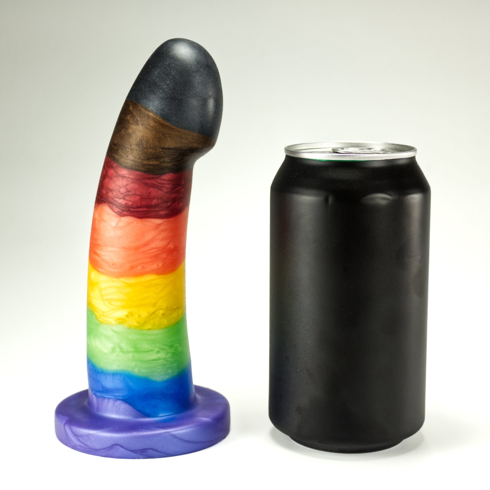 Side view of the Sidekick Medium next to a standard soda can, showing that the dildo is a little taller and about two thirds of the width of the can.