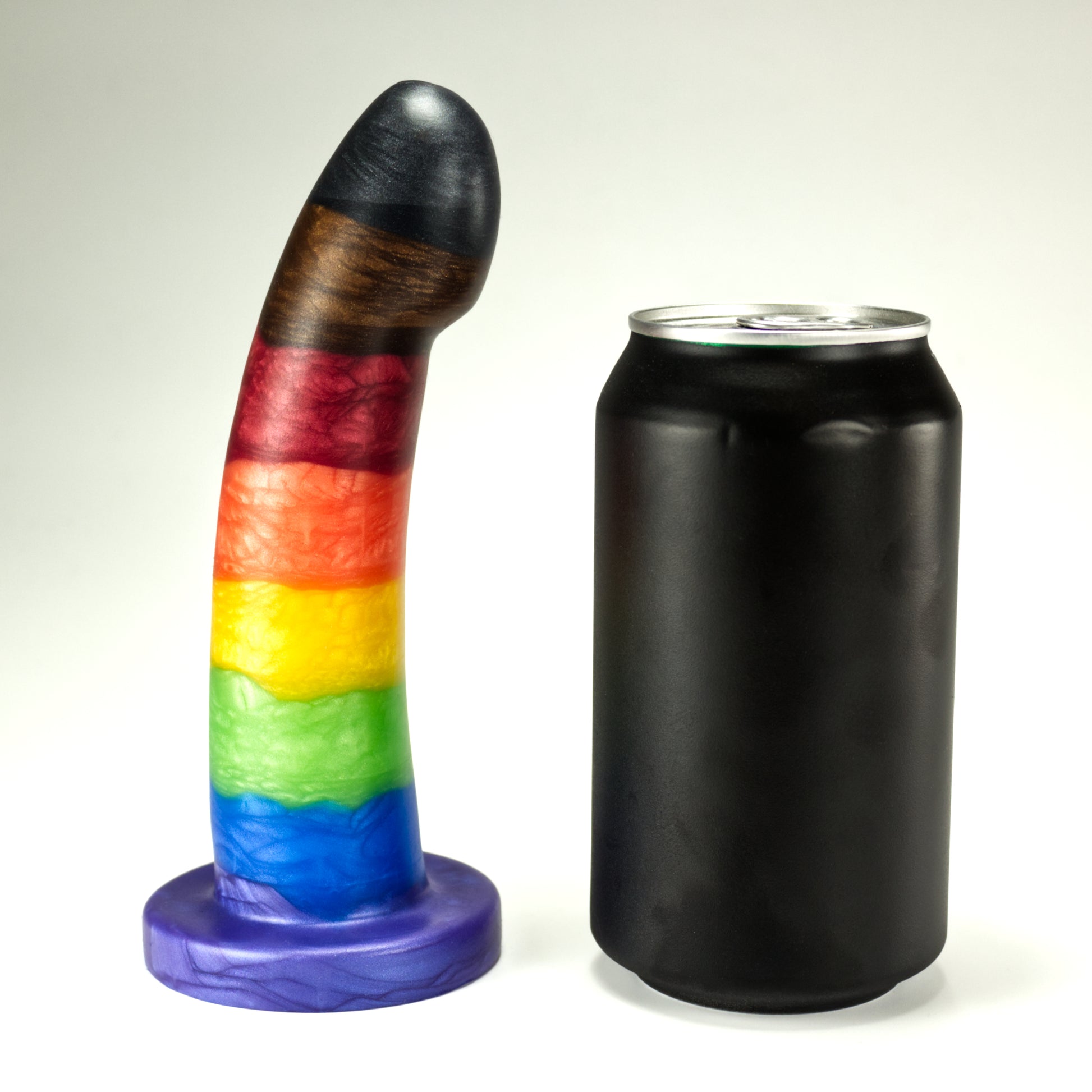 Side view of the Sidekick Small next to a standard soda can, showing that the dildo is a little taller and a little more than half of the width of the can.
